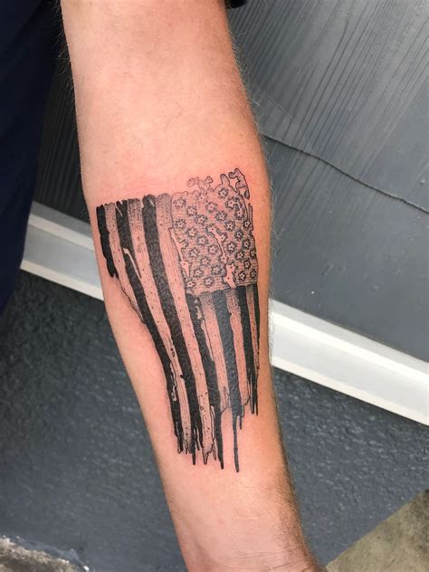 "Honoring Old Glory: The Meaning Behind Tattered American Flag Tattoos"