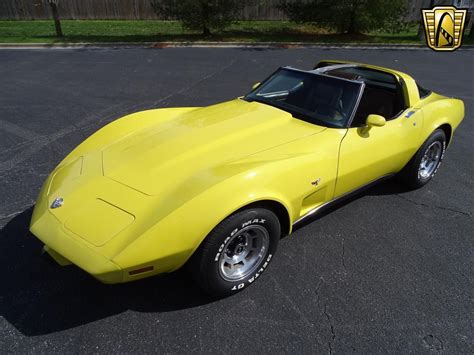 a yellow car parked in a parking lot