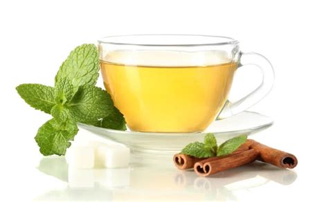 Cup of tea with mint,cinnamon and lime isolated on white Stock Photo by ©belchonock 20388921