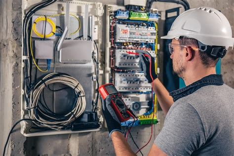 Free Photo | Man an electrical technician working in a switchboard with ...