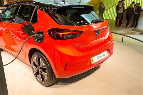 Visitors of a Automobile Fair talking to Staff about Electric Cars ...