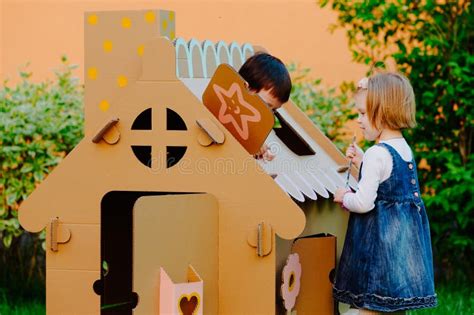 Children Painting on the Cardboard Playhouse. Stock Image - Image of ...