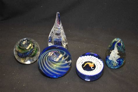 Five vintage glass paperweights including three signed by artists