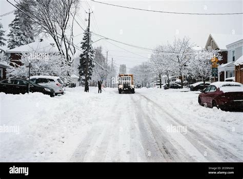 A yellow City of Ottawa snow plow truck roams the Glebe streets during a fresh dumping of 25cm ...