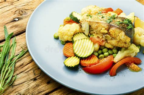 Baked fish with vegetables stock image. Image of dieting - 190922663