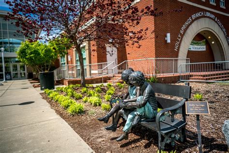 sculpture in front of holly springs nc library