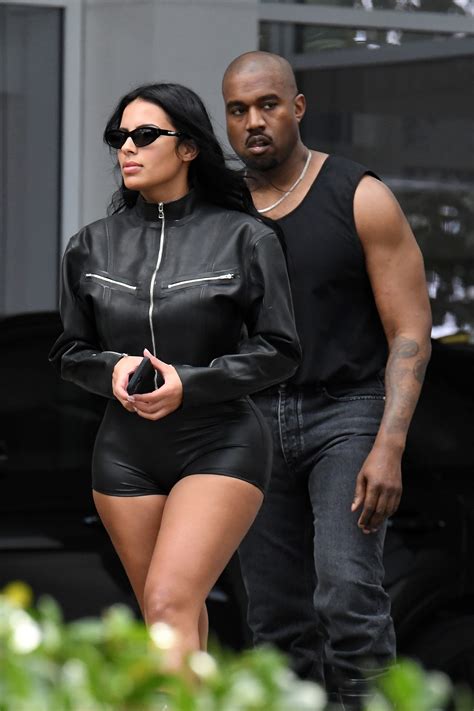 Kanye West's new girlfriend Chaney Jones nearly spills out of tiny leather short shorts during ...