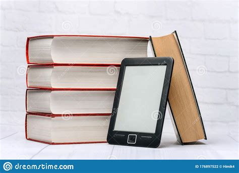 A Stack of Paper Books and an Electronic Book on a White Background Stock Photo - Image of ...