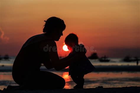 Silhouette Of Mother And Daughter On Sunset Beach Stock Photo - Image ...