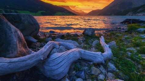 View of dramatic sky and sunset at lake Lago di Resia (Reschensee), Alps, South Tyrol, Italy ...