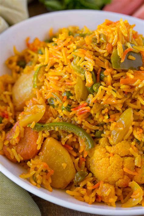 Vegetable Biryani is a bold and flavorful Indian rice dish with bell peppers, peas, carrots and ...