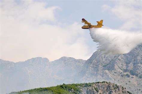 Airplane droping water on fire 11807867 Stock Photo at Vecteezy