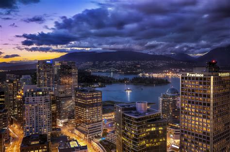 The view of Coal Harbour, Vancouver as the sun sets behind Stanley Park to the west. Full HD ...