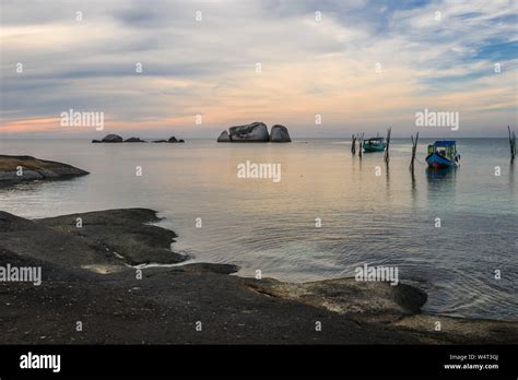 Two boats anchored at sea, Tanjung Pandan Beach, Indonesia Stock Photo ...