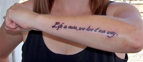 a woman with a tattoo on her arm saying life is ours, we're not very