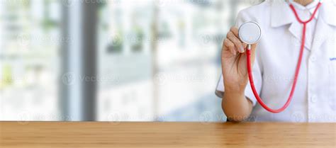 Doctor holding a stethoscope in a hospital background. Medical concepts and quality hospital ...