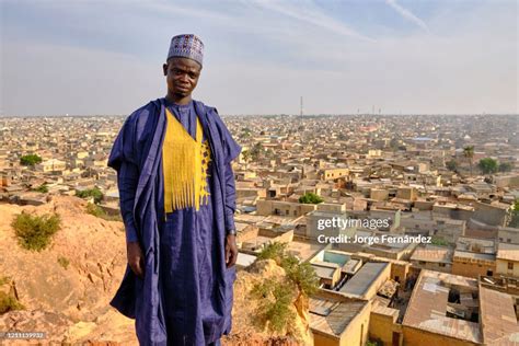 Portrait of a young man dressed in typical Hausa costume posing from ...