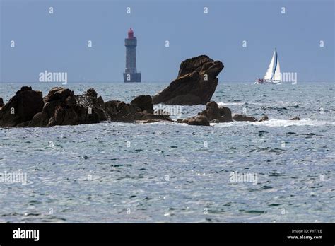 The Jument lighthouse and a sailboat, Ushant island, Brittany, France Stock Photo - Alamy