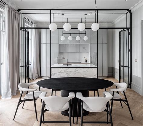 A Black-Framed Glass Wall Separates The Kitchen From The Dining Room In This Apartment ...