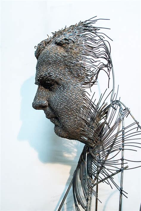 a metal sculpture of a man's face and hair