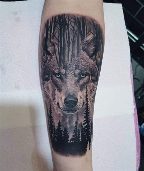 Wolf with blue eyes in a forrest black and grey forearm tattoo | Ojos ...