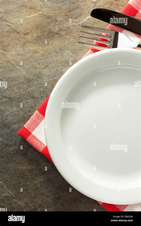 plate, knife and fork on napkin cloth Stock Photo - Alamy