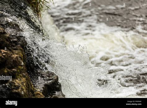 Raging river water passing a waterfall Stock Photo - Alamy