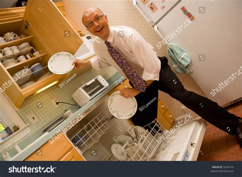 Businessman Putting Dishes Away Stock Photo 6240742 : Shutterstock