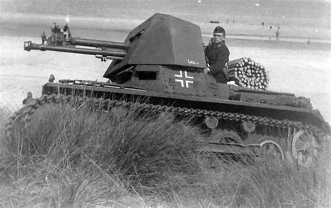 an old photo of a man sitting on top of a tank in the sand dunes