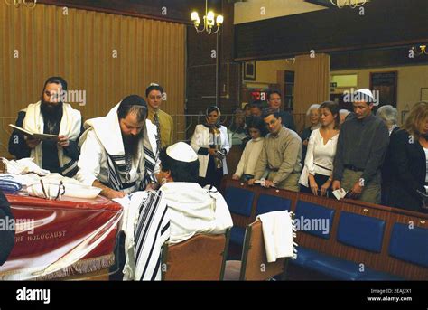 A Brit Milah ceremony takes place on the bimah of the synagogue in the Solihull, West Midlands ...