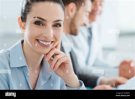 Professional business team working at office desk, smiling confident businesswoman posing and ...