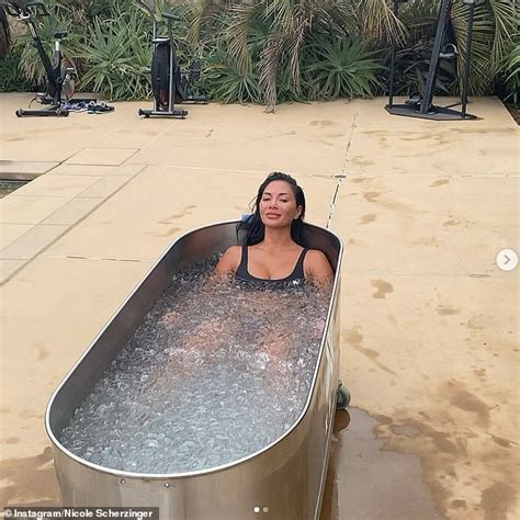 Nicole Scherzinger sizzles in a black bikini as she submerges in a freezing cold ICE bath ...