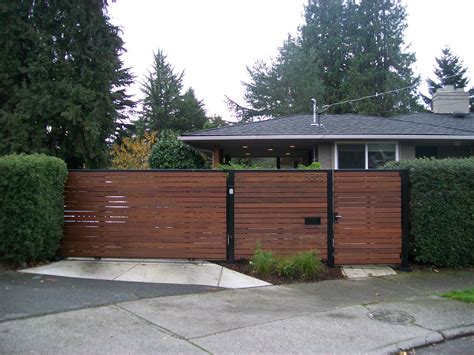 Wooden privacy slide gate with a matching pedestrian gate #wood #iron #privacy… Modern Landscape ...