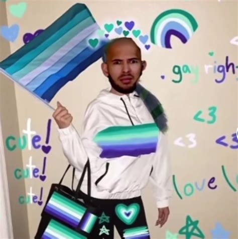 a man holding a large bag while standing in front of a wall with hearts and rainbows on it