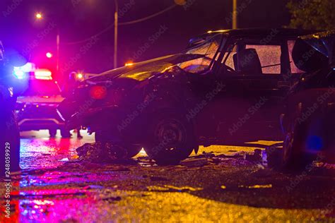 Night road car accident. Car crash in police lights. Stock Photo | Adobe Stock