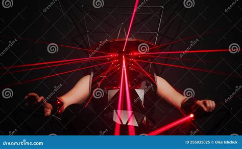 Wide Shot of Caucasian Man in Stage Costume with Red Laser Beam Sitting on Metal Chair. Portrait ...