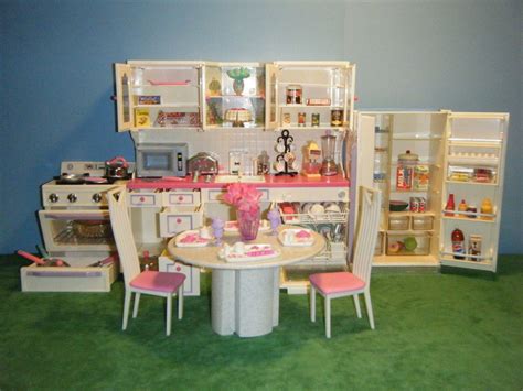 a doll house kitchen and dining room set with table, chairs, refrigerator and stove