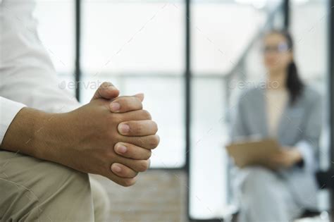 Close up of man hands clenched in stress while discussing his stress, anxiety. Stock Photo by ijeab