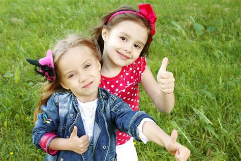 Two little girls friends. Thumbs up — Stock Photo © sunny_baby #5939467