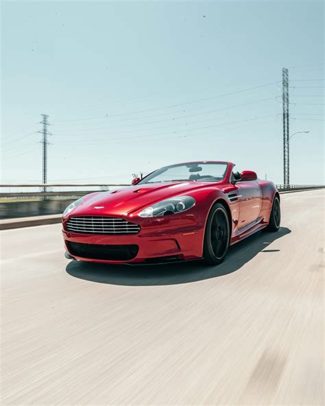 Red Aston Martin Vantage running on road photo – Free Car Image on Unsplash