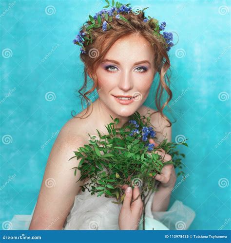 Young Smiling Tender Woman with Blue Flowers on Light Blue Background. Spring Beauty Portrait ...