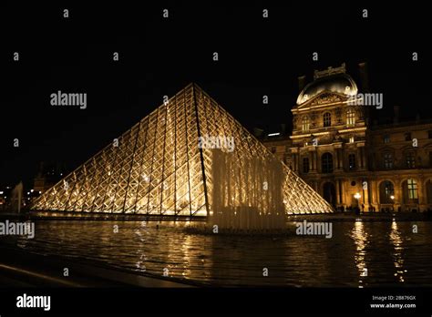 Louvre and Glass Pyramid at Night Stock Photo - Alamy