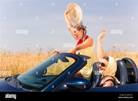 friends having summer joyride in convertible car Stock Photo - Alamy