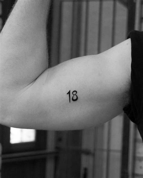 Number "18" tattoo done on the bicep.