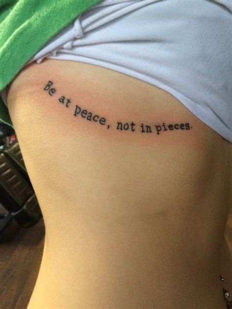 a woman with a tattoo on her stomach saying, no at peace, not in pieces