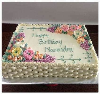 a birthday cake with white frosting and flowers on it