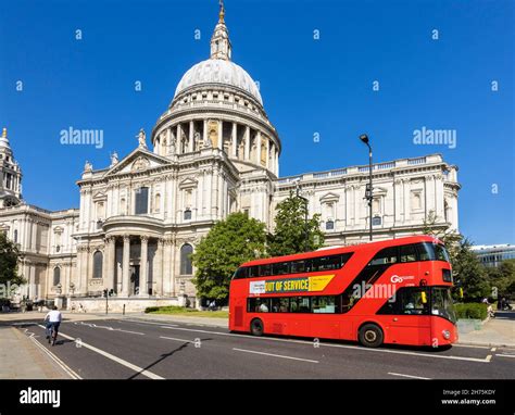 A double decker red London bus in front of the iconic St Paul's ...