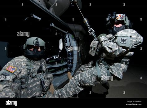 Crew Chief sits in the doorway of a UH-60 Black Hawk medevac helicopter ...