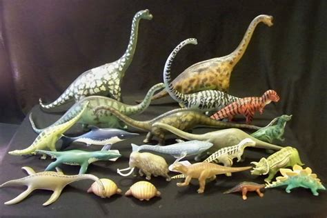 there are many toy dinosaurs on the table