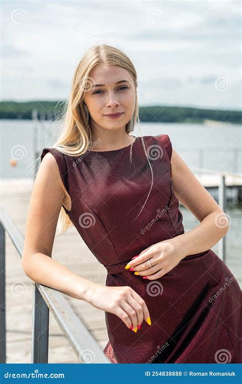 Beautiful Blond Girl in a Long Dark Red Dress Posing on the Pond Stock Photo - Image of model ...